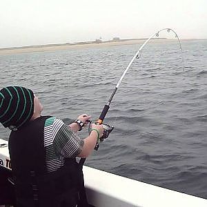 Kid live-lining mackerel for striped bass on Cape Cod